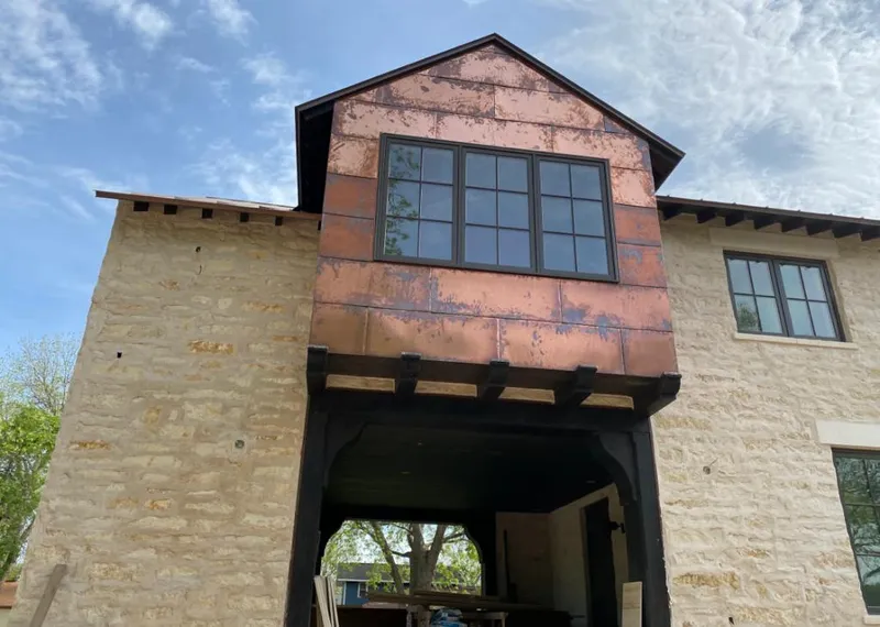 Copper metal panel facade on a stone building for Skylight Installation in Red Bluff